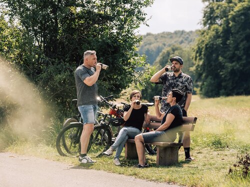 Menschengruppe trinkt alkoholfreies Bier in der Natur
